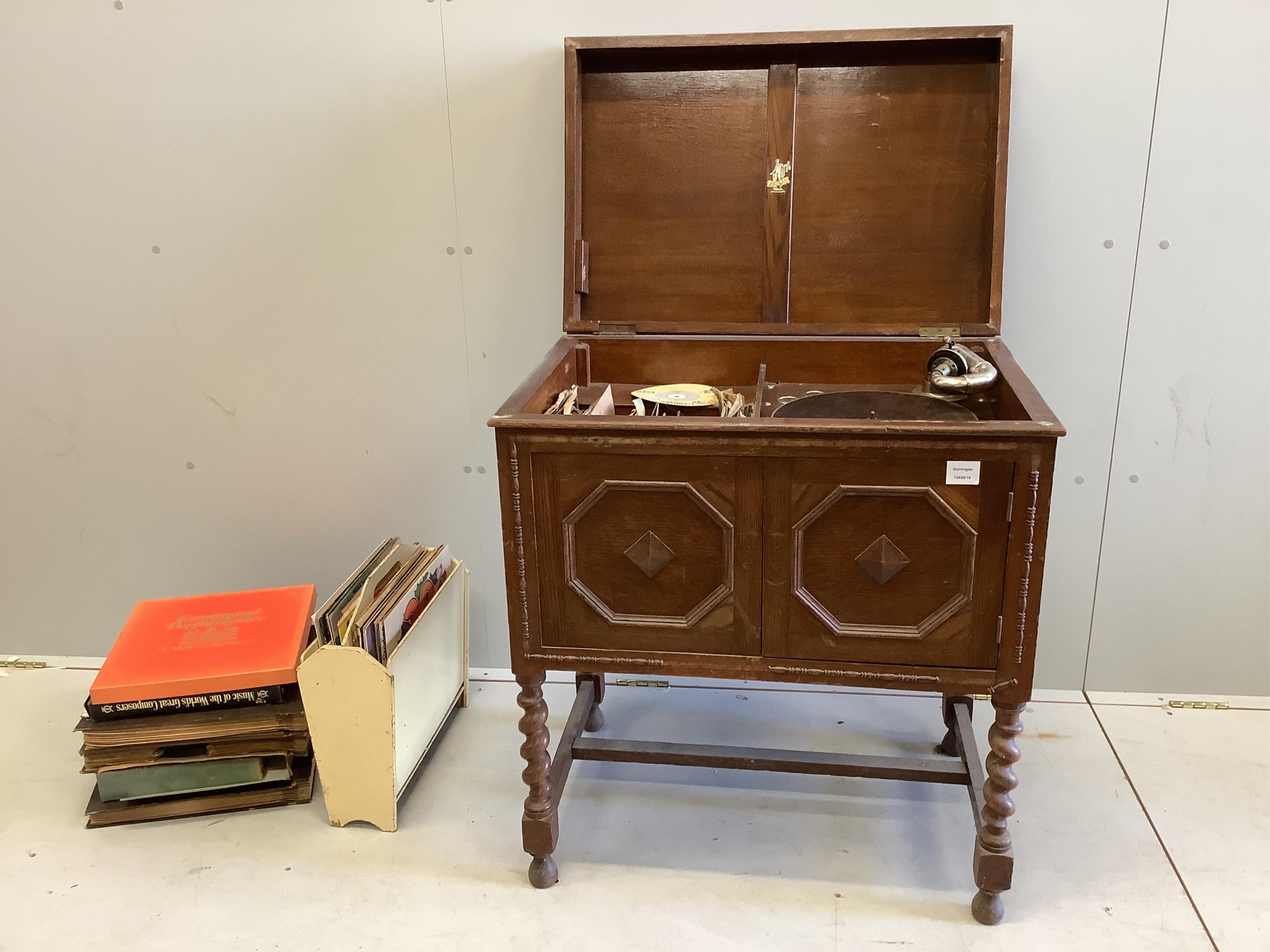 An oak cased Apollo gramophone, width 74cm, depth 50cm, height 84cm, with a small quantity of albums